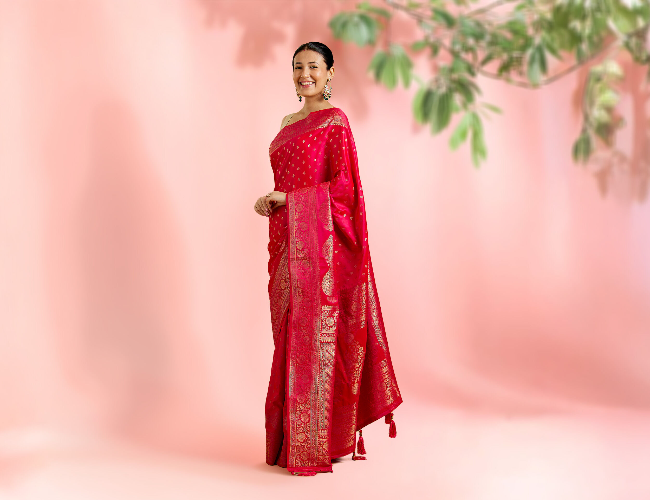 Graceful woman wearing a classic red silk saree, reflecting timeless tradition and elegance.